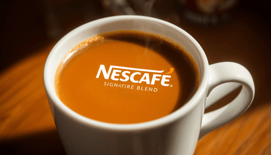 A steaming cup of Nescafé Signature Blend coffee