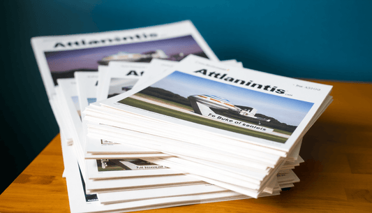 A stack of Atlantis product manuals and brochures