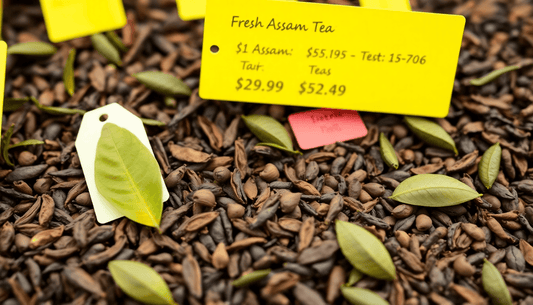 Fresh Assam tea leaves with pricing tags in marketplace
