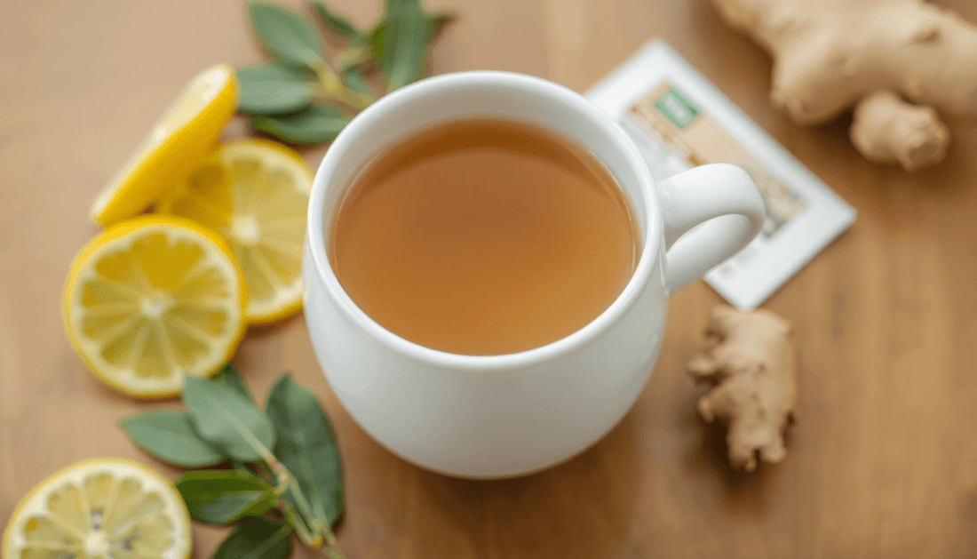 A cup of lemon grass ginger tea with tea premix packet