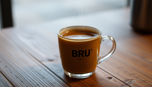 A steaming cup of BRU hot coffee on a wooden table