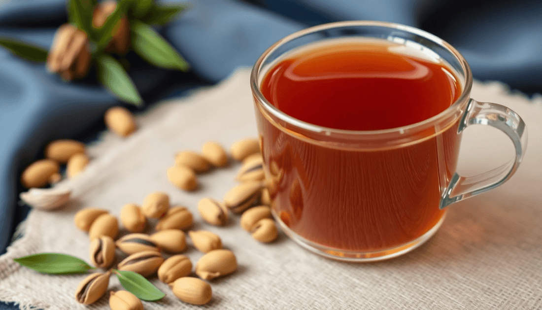 A cup of cardamom tea with cardamom pods and tea premix pack