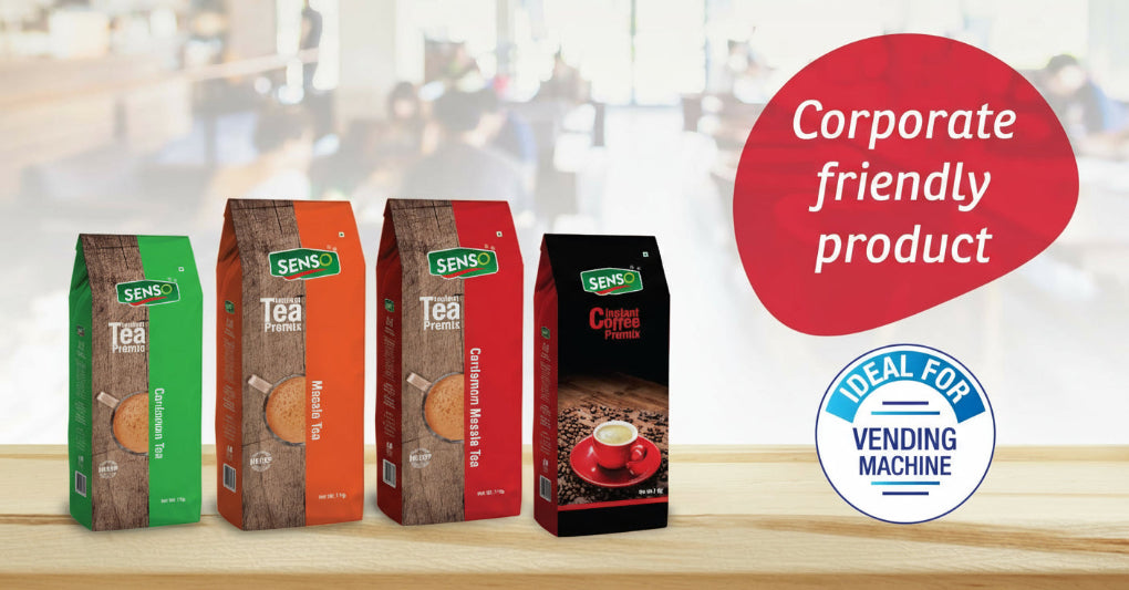 Four Sens branded tea and coffee packages on a wooden surface with a blurred background.