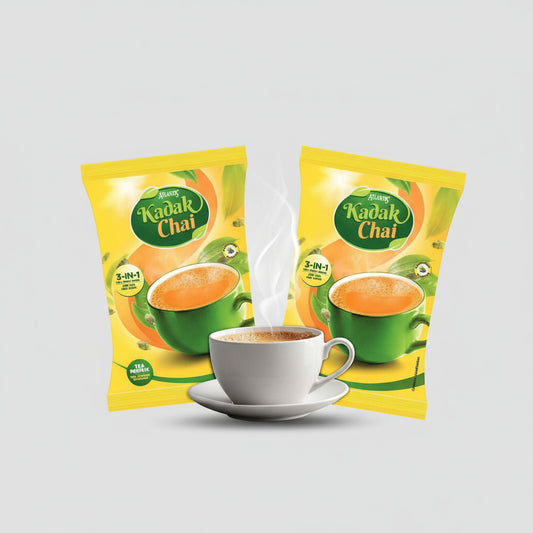 Amazon Atlantis Kadak Tea Premix wholesale packs with steaming cup of rich tea and green leaves background