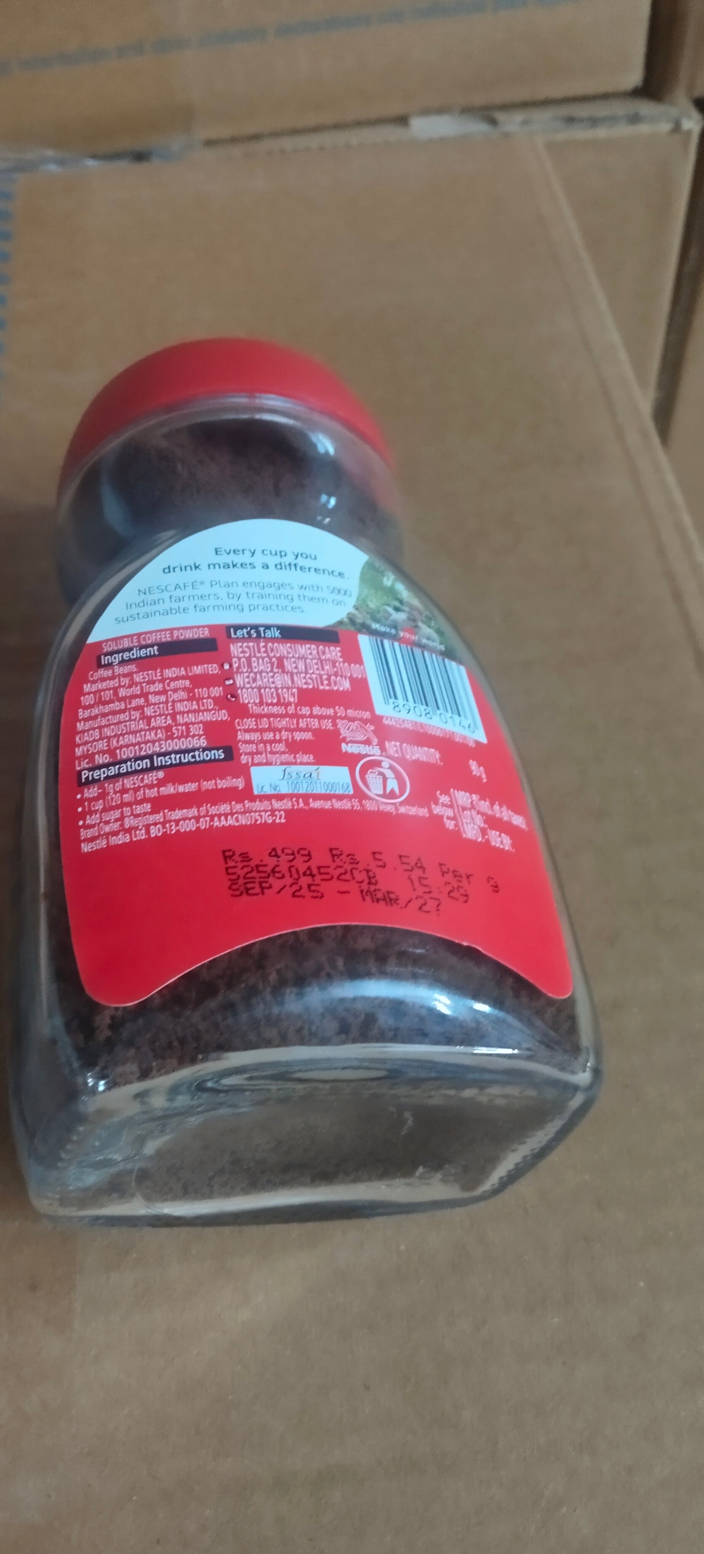Glass jar of ground coffee with red lid showing label and information for Amazon vending coffee Noida