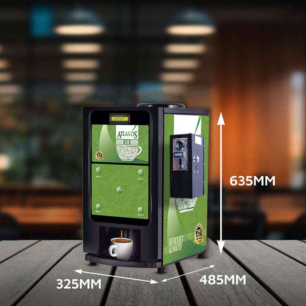 Atlantis coin operated coffee vending machine 2 lane with green panels and coin slot on wooden table