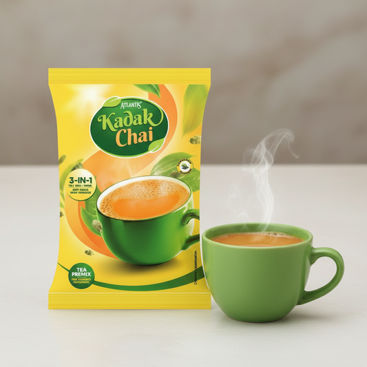 Atlantis Kadak Tea Premix 1 kg packet with a steaming cup of kadak chai in a green mug
