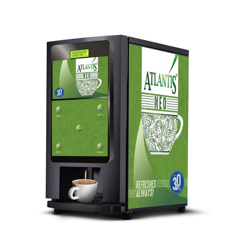 ATLANTIS NEO tea coffee vending machine with green design dispensing coffee into a white cup