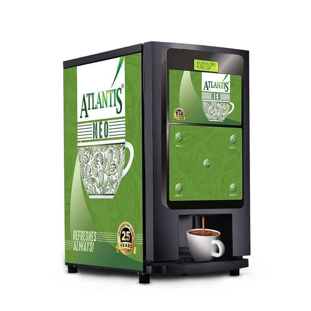 Atlantis Neo tea coffee vending machine with black body and green branded panels dispensing coffee into a white cup