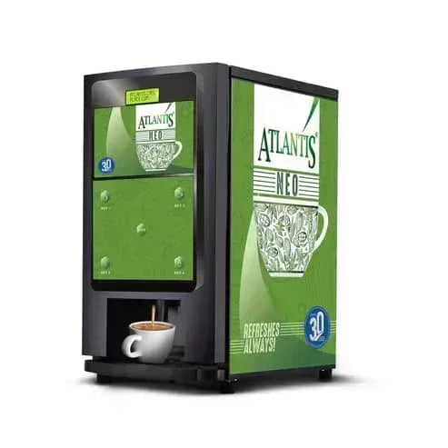 Atlantis Neo coffee vending machine with green panel and cup dispensing coffee