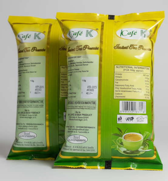Cafe K instant tea premix cardamom flavor packets with nutritional information and green cup of tea on packaging
