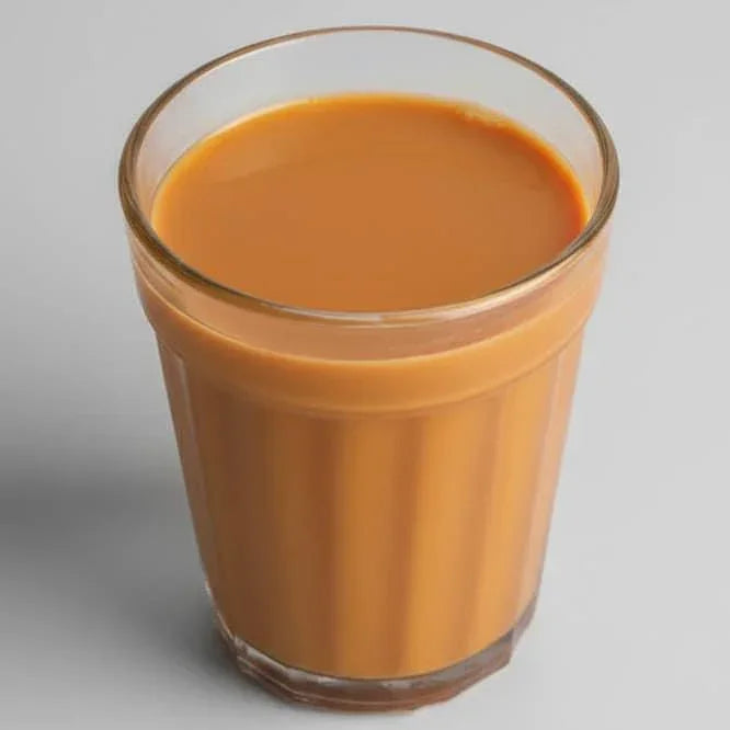 Glass of Cherise Tapri premium chai with creamy texture served in a clear glass