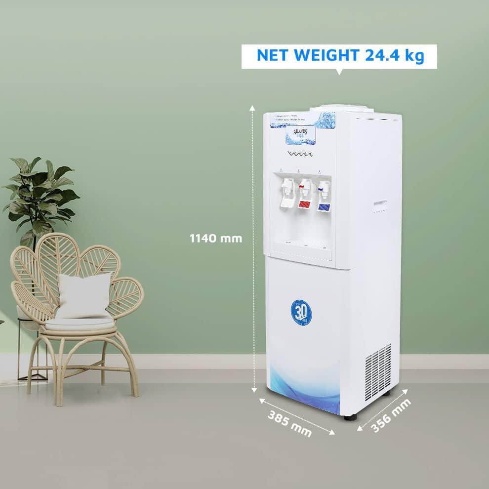 White Atlantis super water dispenser with three taps and 30-liter capacity next to a chair and plant