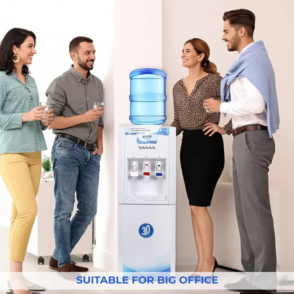 Office workers enjoying water from Atlantis super water dispenser in a modern workplace setting