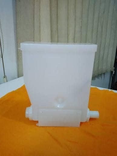 White plastic Godrej coffee machine replacement part by COFFEE WALLA on orange surface