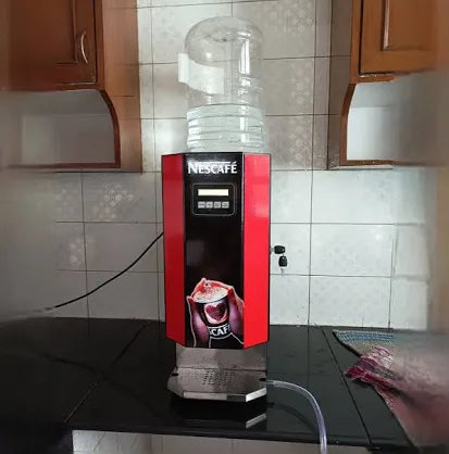Nescafe 2 lane coffee machine price shown with red and black design and water dispenser on top