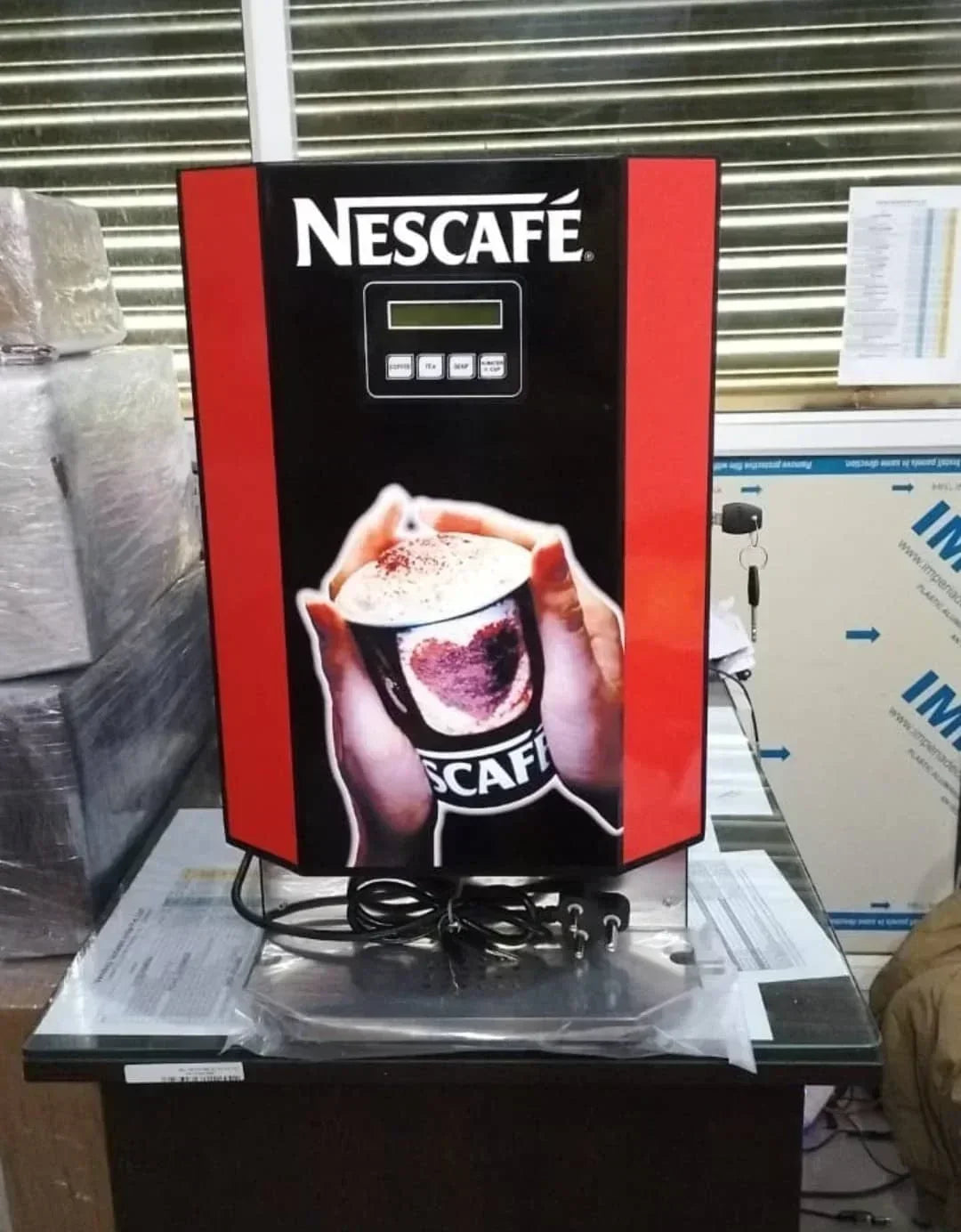 Nescafe coffee machine 3 line price online displayed on a red and black vending coffee machine