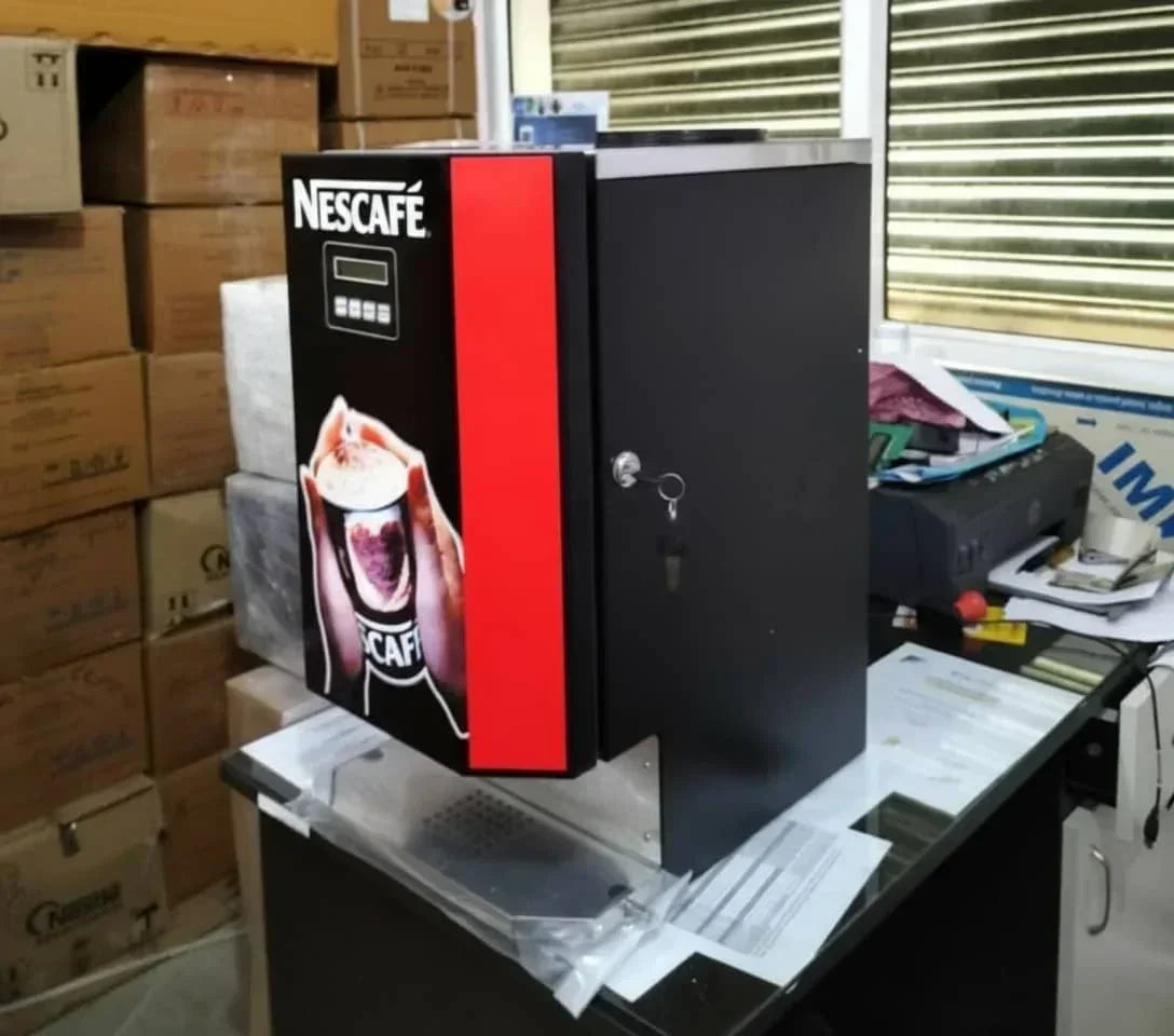 Nescafe coffee machine 3 line price online displayed on black and red vending coffee machine in office
