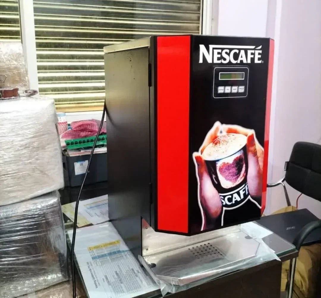 Nescafe coffee machine 3 line price online shown on a black and red vending machine in office setting