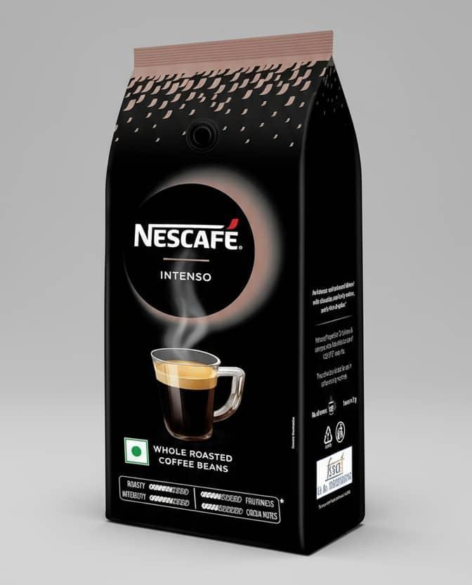 Nescafe Intenso whole roasted coffee beans Delhi pack with steaming black coffee cup on black background