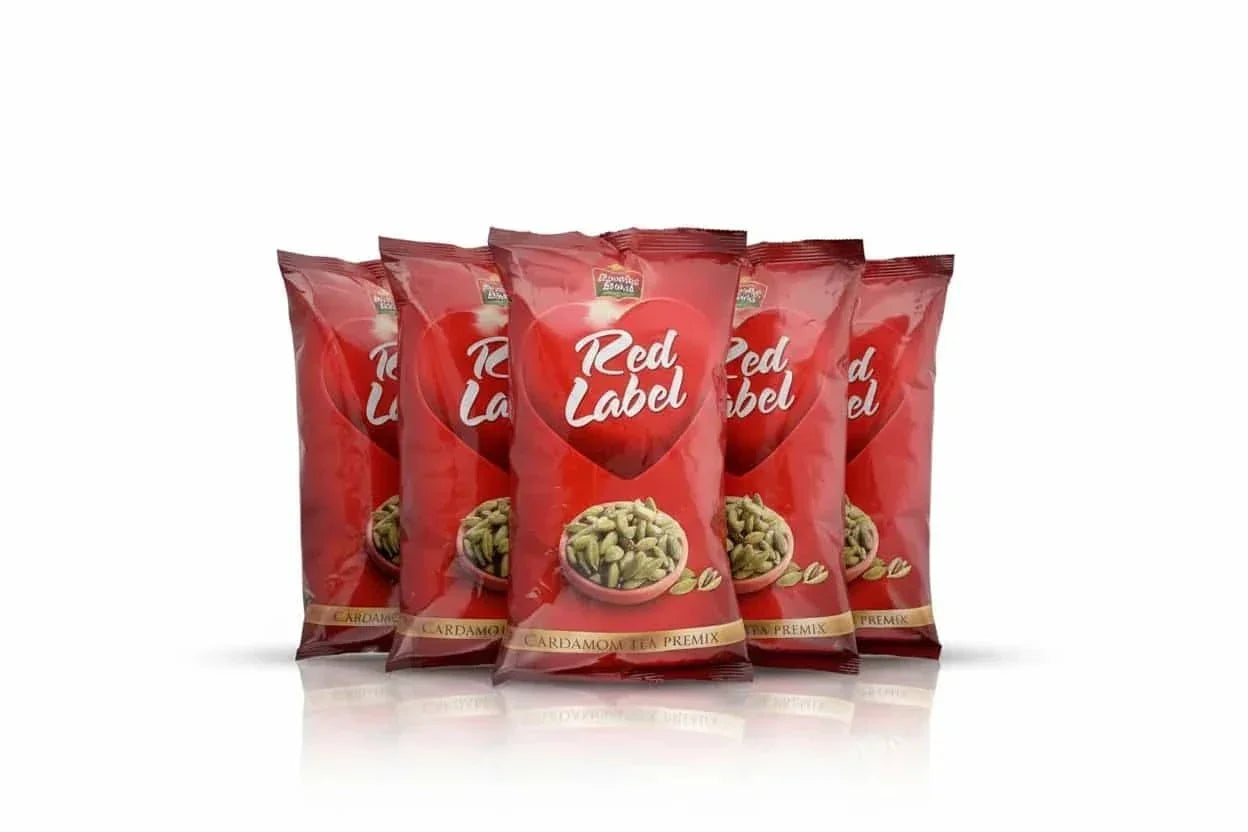 Red label cardamom Tea Premix 1kg packets by COFFEE WALLA with cardamom spice design on packaging